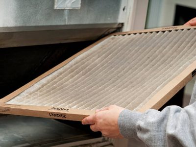 Home owner changing their dirty air filter